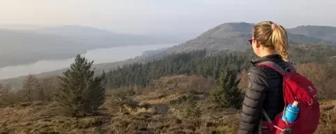 Standing with my dog overlooking a lake in the Lake District, a peaceful moment of space and reflection.